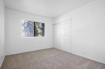 A room with a window and a door.